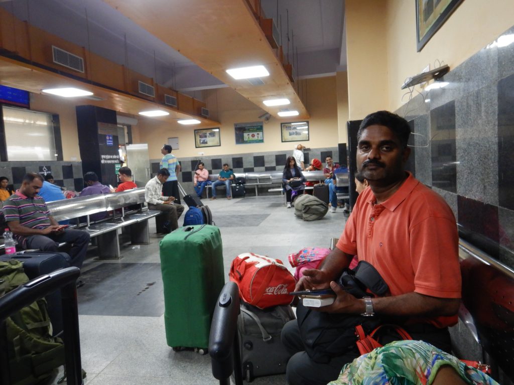 I am half asleep at the New Delhi Railway station waiting room